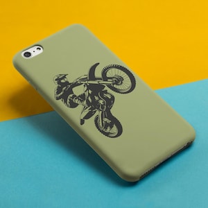May include: A green phone case with a black silhouette of a motocross rider performing a wheelie.