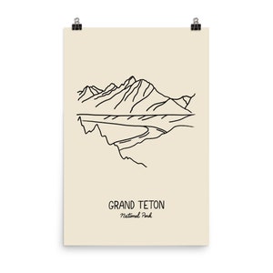 May include: A line drawing illustration of the Grand Teton National Park in Wyoming. The illustration shows a mountain range with a river flowing through it. The text "Grand Teton National Park" is written below the illustration.