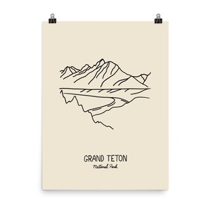 May include: A line drawing illustration of a mountain range with the text "GRAND TETON National Park" below.