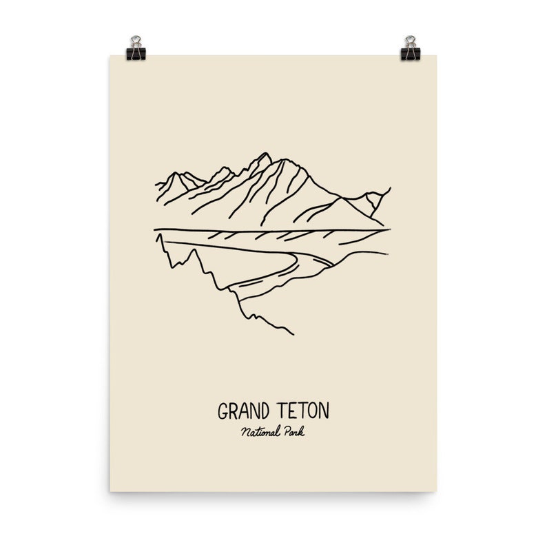 May include: A line drawing illustration of a mountain range with the text "GRAND TETON National Park" below.