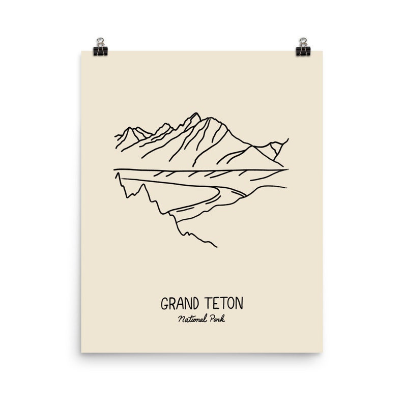 May include: Line art illustration of a mountain range with a river flowing through it. The text "GRAND TETON National Park" is below the image.
