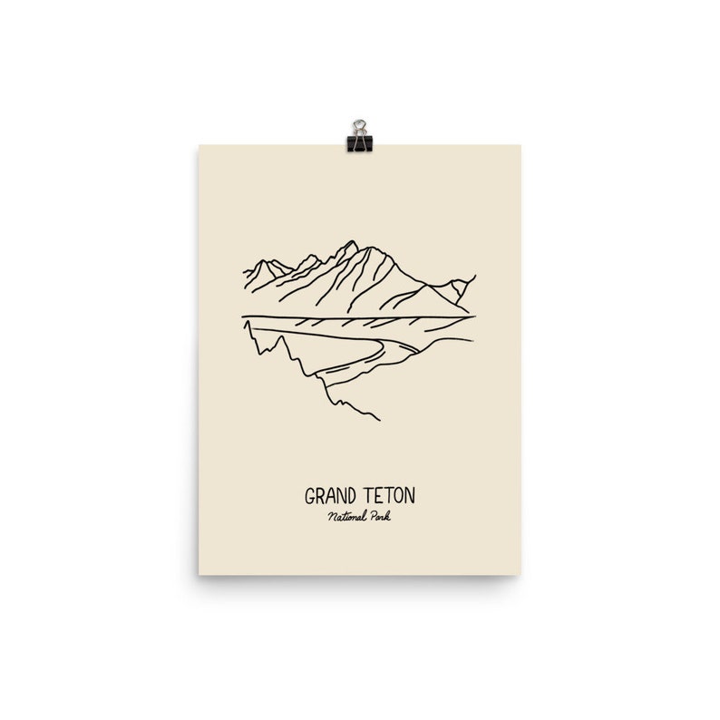 May include: Line art illustration of the Grand Teton National Park in Wyoming. The image features a mountain range with a river flowing through it. The text "Grand Teton National Park" is printed below the image.
