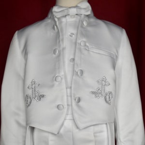 May include: White satin suit jacket with a stand-up collar and silver embroidered crosses on the front.