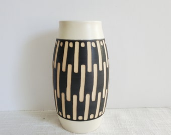 Black and white striped vase, medium ceramic vase, varied hand-carved bold vertical stripes, matte white glaze, curved vessel shape vase