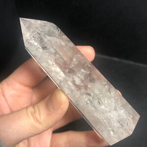 May include: A set of three ceramic mugs with a speckled, matte finish. The mugs are in shades of cream, light gray, and dark gray. Each mug has a simple, modern design and a rounded handle. The mugs are likely for coffee or tea.