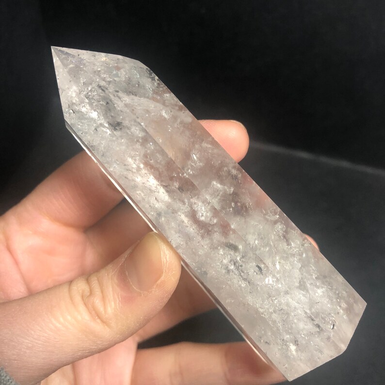 May include: A set of three ceramic mugs with a speckled, matte finish. The mugs are in shades of cream, light gray, and dark gray. Each mug has a simple, modern design and a rounded handle. The mugs are likely for coffee or tea.