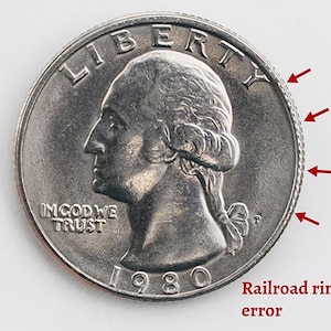 May include: A close-up of a silver 1980 quarter coin with a railroad rim error. The coin features a profile of a person and the words "LIBERTY" and "IN GOD WE TRUST". The year "1980" is visible.
