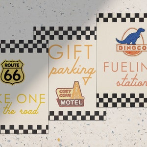 May include: Three printable signs with a chequered border and a retro theme. The first sign says "Take one for the road" and features a Route 66 sign. The second sign says "Gift parking" and features a motel sign. The third sign says "Fueling station" and features a Dinoco sign.