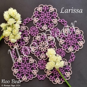 Op de afbeelding: Een handgemaakt, lavendelkleurig kanten kleedje met een bloemmotief, geaccentueerd met witte details. Het kleedje wordt omringd door takjes witte bloemen. De teksten "Larissa" en "Noo Bear" zijn zichtbaar.