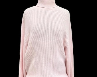May include: A pale pink turtleneck sweater with a ribbed knit texture.