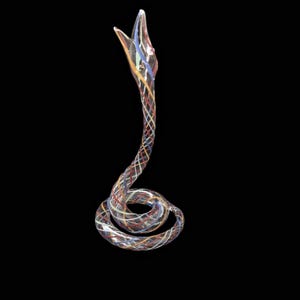 May include: A clear glass sculpture of a coiled snake with an upright head and open mouth. The body features a decorative lattice pattern of thin, intersecting lines in shades of blue, red, yellow, and white, creating a colourful, translucent effect.