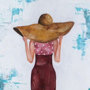 May include: A painting of a person wearing a large brown sun hat and a red and white polka dot dress. The person is standing on a white background with blue and pink brushstrokes.