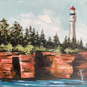 May include: A painting of a white lighthouse with a red roof, standing on a rocky cliff overlooking a blue body of water. Green trees line the cliff, and the sky is a light blue with white clouds.