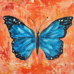 May include: A blue butterfly with black markings and white spots on its wings is painted on a textured orange background.