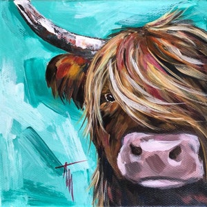 May include: A painting of a Highland cow with long, brown and blonde fur. The cow's face is visible, with a pink nose and brown eyes. The background is a turquoise blue.