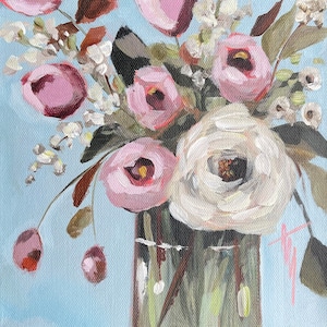 May include: A painting of a bouquet of pink and white flowers in a clear glass vase. The flowers are arranged in a loose, natural style, and the vase is sitting on a light blue background.