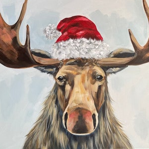 May include: A painting of a moose wearing a red and white Santa hat. The moose has brown antlers and a brown face with a pink nose. The background is a light blue.