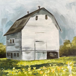 May include: A white barn with a brown roof stands in a field of yellow flowers. The barn has two windows on the upper level and several windows on the lower level. The barn is painted white with a light gray trim.
