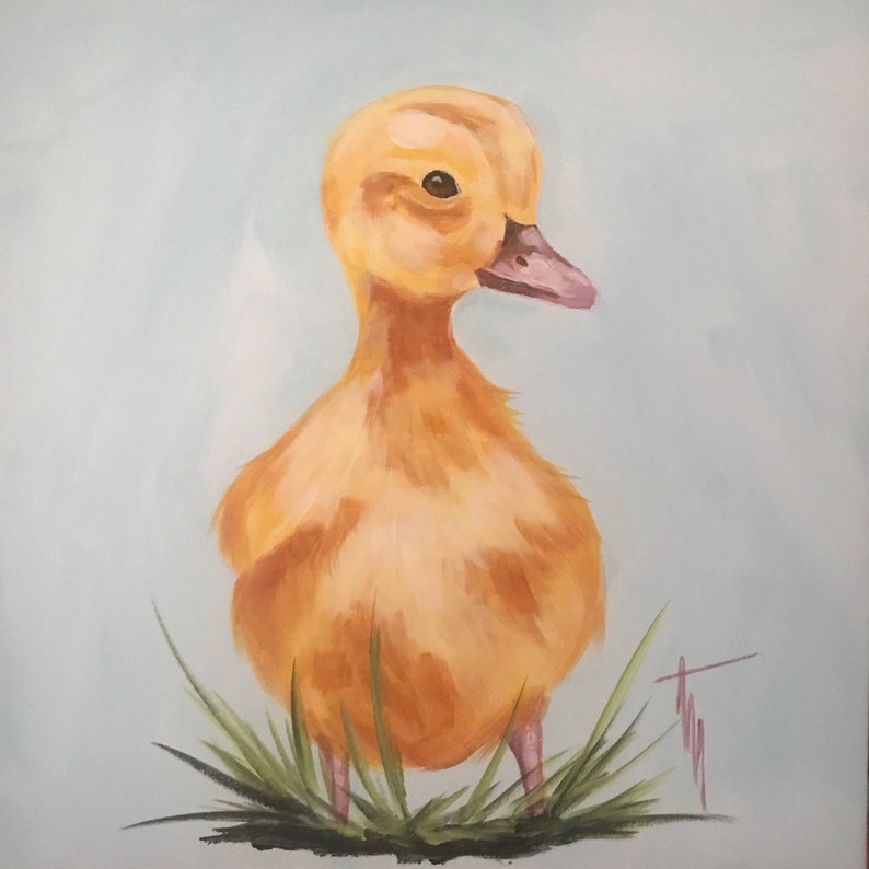 May include: A yellow duckling with a pink beak stands on green grass against a light blue background.