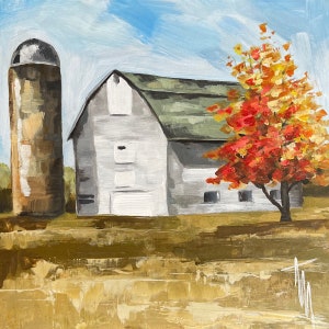 May include: A white farmhouse with a red roof and a silo in front of it. A bright red and orange tree is in the foreground.