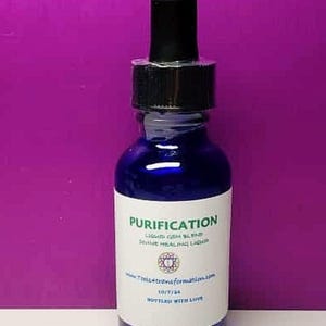 May include: A cobalt blue glass bottle with a black dropper. The label reads "Purification" and "Liquid Gem Blend Divine Healing Liquid". The bottle is filled with a blue liquid. The background is a solid purple.