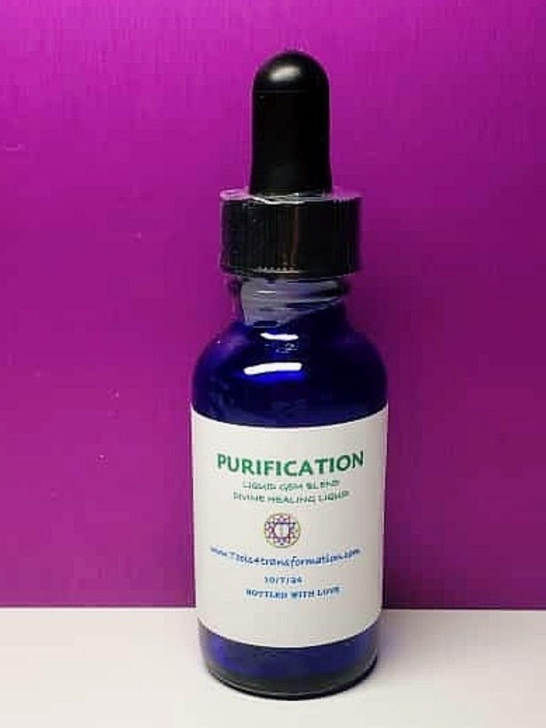 May include: A cobalt blue glass bottle with a black dropper. The label reads "Purification" and "Liquid Gem Blend Divine Healing Liquid". The bottle is filled with a blue liquid. The background is a solid purple.