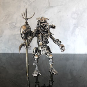 Predator Holding An Alien Head Mace Inspired Recycled Scrap Metal Art
