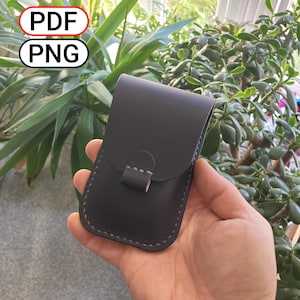 May include: A dark grey leather case with a flap and grey stitching. The case is held in a hand, with the text "PDF" and "PNG" in the background.