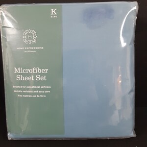 May include: A blue package for a king-sized microfiber sheet set from Home Expressions by JCPenney. The package features the brand logo and text that reads "Microfiber Sheet Set" and "Brushed for exceptional softness, Wrinkle resistant and easy care, Fits mattress up to 16 in."