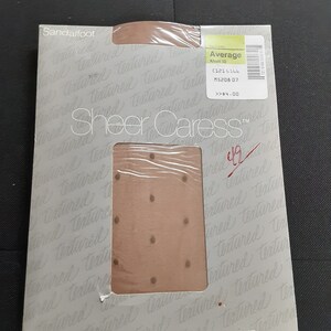 May include: A package of Sheer Caress™ brand sheer hosiery with a polka dot pattern. The package is labeled "Sandalfoot" and "Average Khaki 52". The price is $4.00. The package is from JCPenney.
