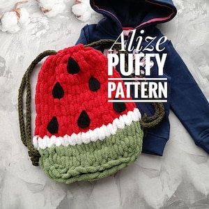 May include: A red and green crocheted watermelon-shaped drawstring bag with black seeds. The bag is made with Alize Puffy yarn and has the text "Alize Puffy Pattern" on it.