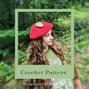 May include: A crochet pattern for a red apple beret with a green leaf. The pattern is available on the website OnceUponAStitchNook.