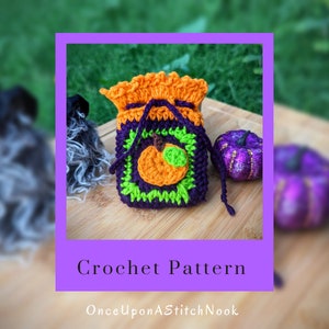 May include: Crochet pattern for a small pumpkin-shaped drawstring bag. The bag is made with orange, green, and purple yarn. The pattern is available on the website OnceUponAStitchNook.