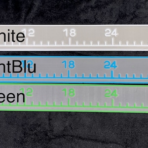 May include: Three rulers with different colored markings. The top ruler is gray with white markings and the text "Gray/white". The middle ruler is gray with light blue markings and the text "Gray/LightBlu". The bottom ruler is gray with green markings and the text "Gray/Green".