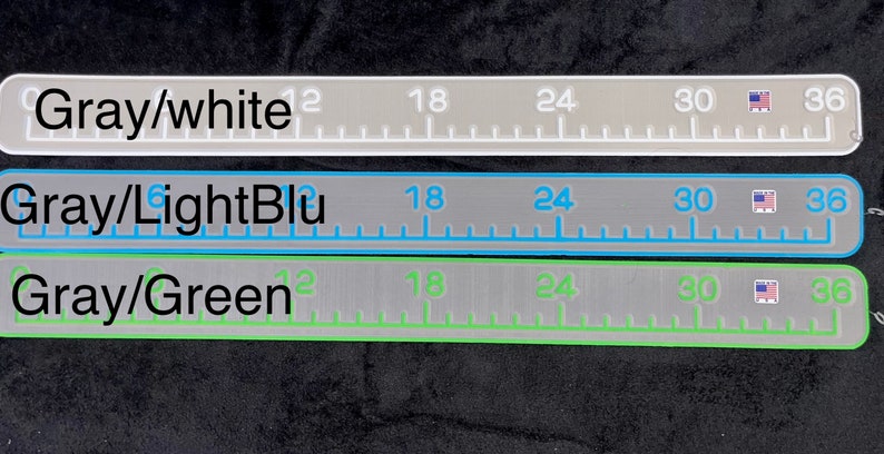 May include: Three rulers with different colored markings. The top ruler is gray with white markings and the text "Gray/white". The middle ruler is gray with light blue markings and the text "Gray/LightBlu". The bottom ruler is gray with green markings and the text "Gray/Green".
