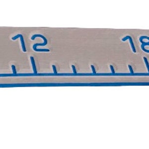 May include: A gray and royal blue ruler with numbers 0, 6, 12, 18, 24, 30, and 36 marked on it.