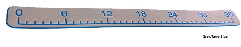 May include: A gray and royal blue ruler with numbers 0, 6, 12, 18, 24, 30, and 36 marked on it.