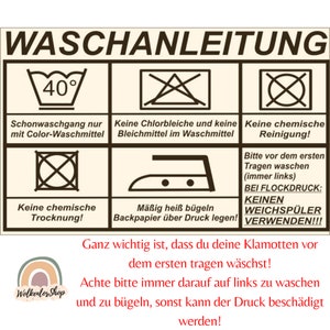May include: Washing instructions for a garment with a 40 degree Celsius maximum wash temperature. The instructions also state that the garment should be washed with color detergent only, should not be bleached, should not be dry cleaned, should be ironed at a medium temperature with a pressing cloth, and should not be put in the dryer. The instructions also state that the garment should be washed on the left side to protect the print.