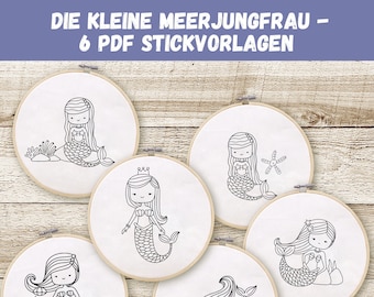 May include: Six black and white line art mermaid embroidery patterns on white fabric in round embroidery hoops. The patterns include mermaids with crowns, seashells, and starfish.