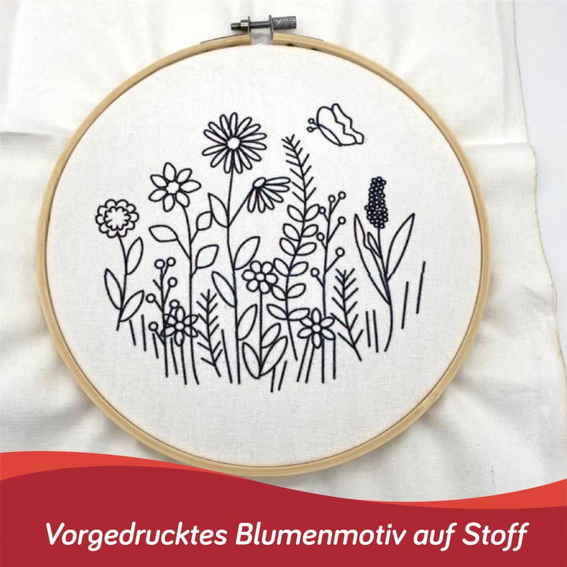 May include: A white embroidery hoop with a black line drawing of flowers, leaves, and a butterfly. The text "Vorgedrucktes Blumenmotiv auf Stoff" is printed below the hoop.