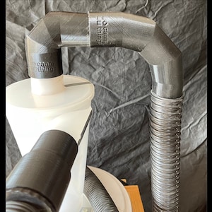 May include: A black 3D printed dust collection system with a clear plastic container and a flexible hose. The system is labeled "Canny Things".