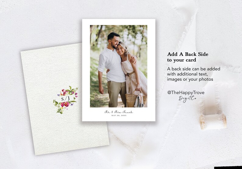 May include: A white card with a floral design and the initials "S/J" in a white rectangle. The card has a photo of a couple embracing in a wooded area. The text "Mr & Mrs Nach" and "MAY 30, 2035" is printed below the photo. The text "Add A Back Side to your card" is printed on the right side of the card. The text "A back side can be added with additional text, images or your photos" is printed below the first line of text. The text "@TheHappyTrove Digitl" is printed below the second line of text.
