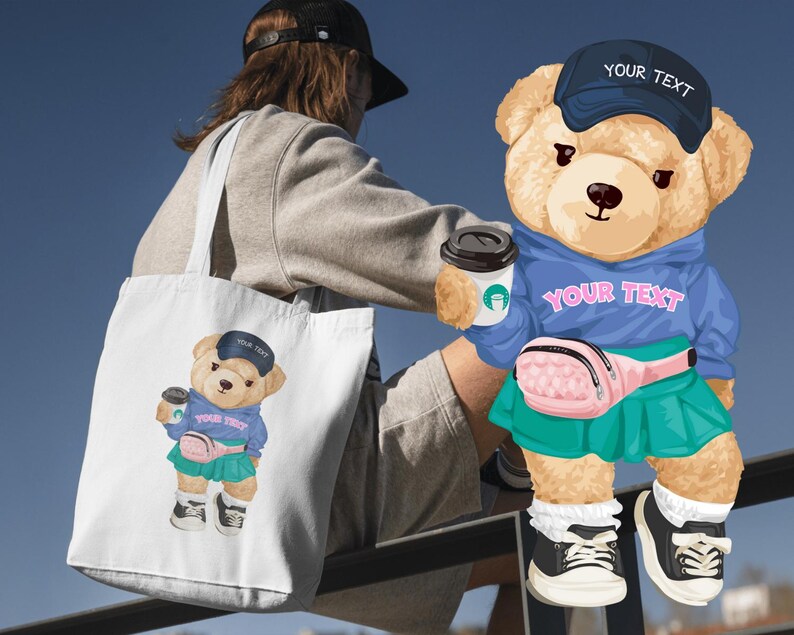 May include: A white tote bag featuring a cartoon teddy bear wearing a blue hoodie, a pink fanny pack, and a green skirt. The bear is holding a coffee cup and wearing a blue cap with the text "YOUR TEXT". The bear is also featured on a blue hoodie.