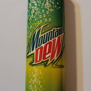 May include: A green and yellow lighter with a Mountain Dew logo and bubbles. The lighter has a silver top and a red button.