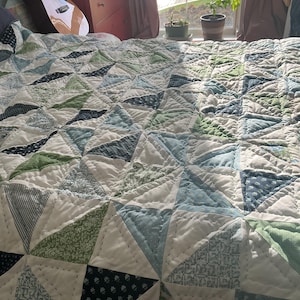 Large patchwork quilt in blues green and whites . Hand quilted .