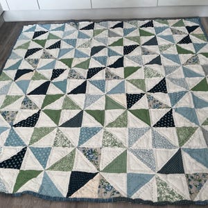 Large patchwork quilt in blues green and whites . Hand quilted .