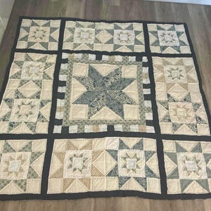 Large double patchwork quilt in blues white and beige . Star pattern hand quilted.