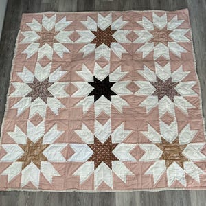 Large double patchwork quilt in beige and browns star pattern. Hand quilted