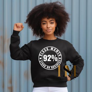 May include: Black sweatshirt with a white circle graphic that says "Black Women Stood On Business 92%".