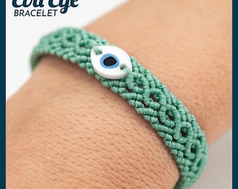 May include: A woven green bracelet with an evil eye charm. The bracelet is made of a woven material and features a white charm with a blue and black eye design. The text "Evil Eye Bracelet" is in the upper left corner.